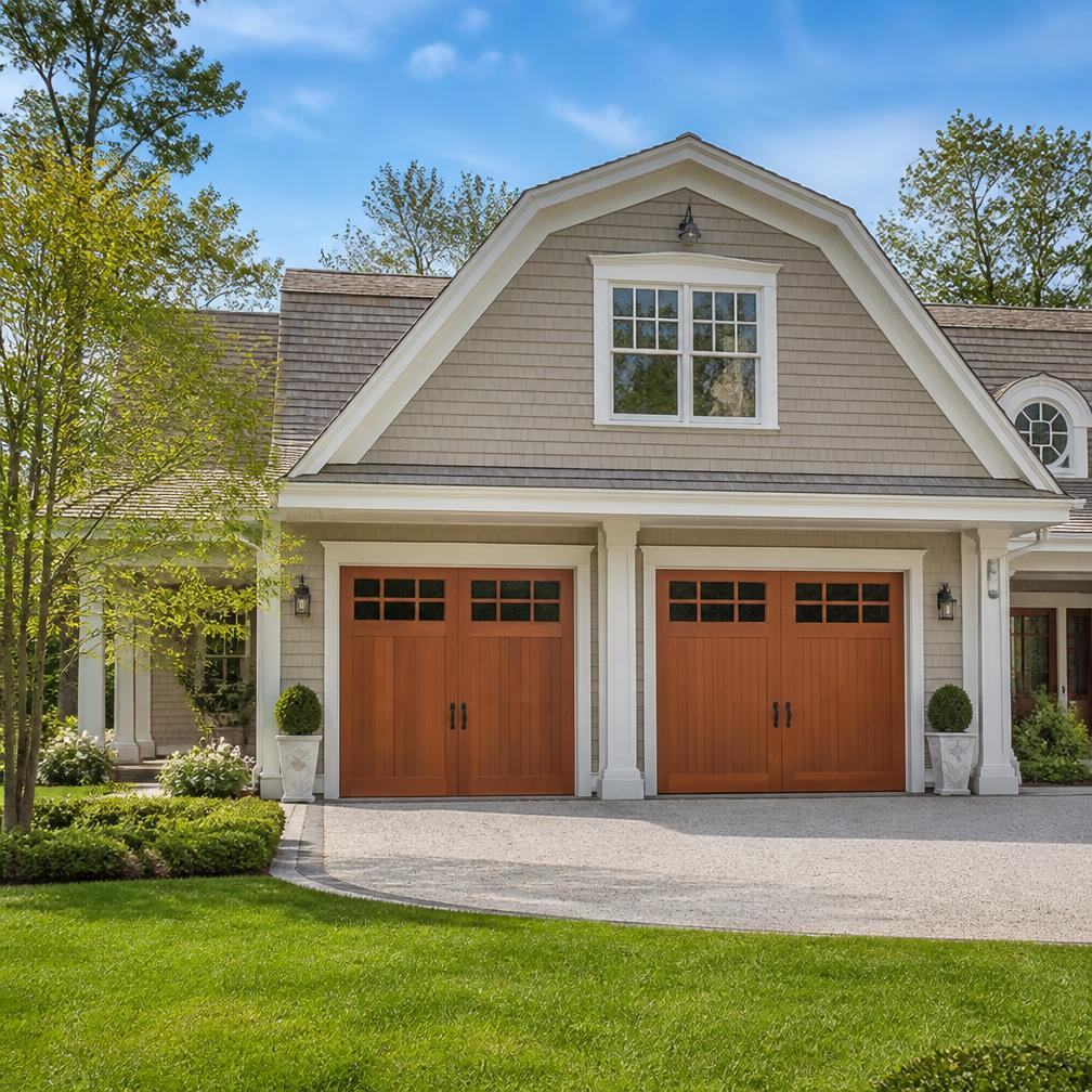New carriage-house style wood garage doors on an upscale home